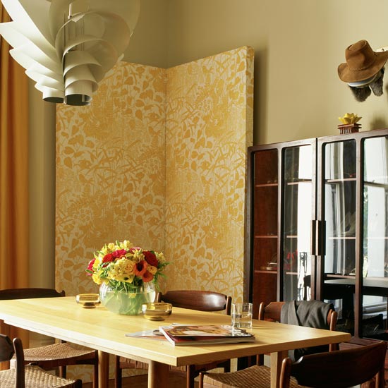 dining area with wishbone chair and louis poulsen pendant,