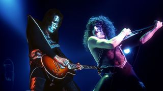 A composite shot of Ace Frehley (left) and Paul Stanley performing onstage. 