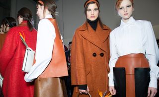 Female models wearing orange and white clothes from the Fendi A/W 2015 collection