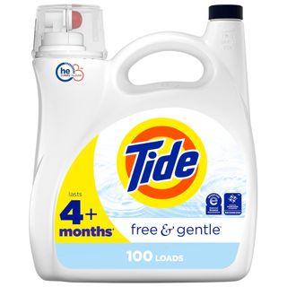 A white bottle of liquid laundry detergent with an orange and yellow circular logo with blue text