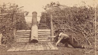 Logs that were carved and painted to resemble cannons were known as "Quaker guns," and were used during the American Civil War by Confederate generals to trick Union opponents. This staged scene was photographed in 1862 by George N. Barnard in Centreville, Virginia.