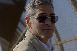 Actor George Clooney, as inventor Frank Walker in Disney's new movie "Tomorrowland," is seen near the perimeter fence outside NASA's Pad 39A at the Kennedy Space Center in Florida.