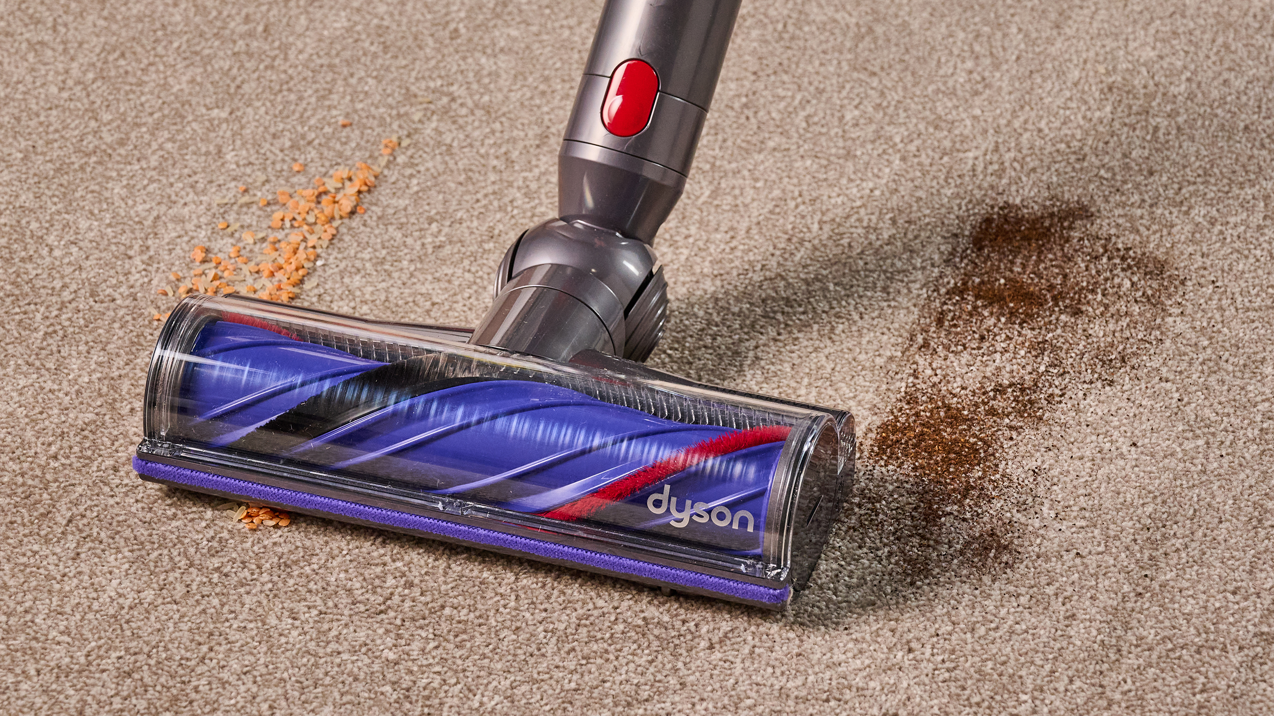 Dyson V11 vacuum being used to clear lentils/rice and dry tea from carpet