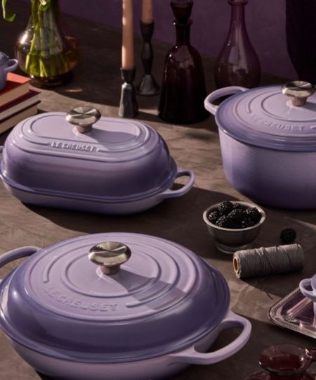 A collection of le Creuset cookware with a dark to light purple gradient colorway
