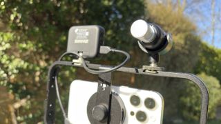Shot of the Shure MoveMic 88+ in horizontal gun mic orientation on a smartphone cage