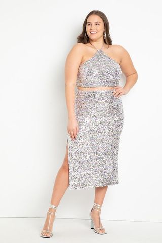 model wearing silver sequin halter top and skirt