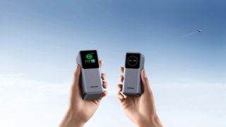 A pair of UGREEN Nexode Power Banks held in outstretched hands