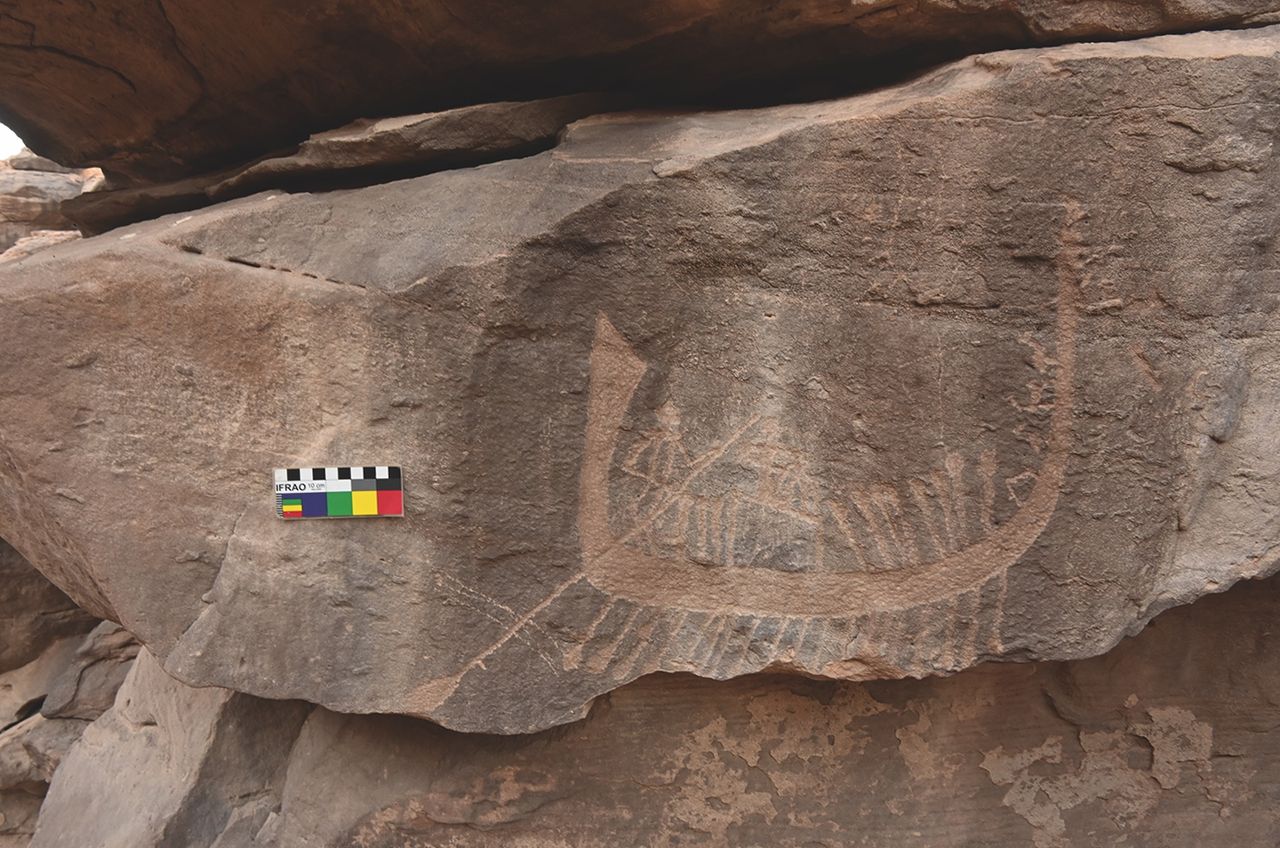 a rock carving of people rowing a boat