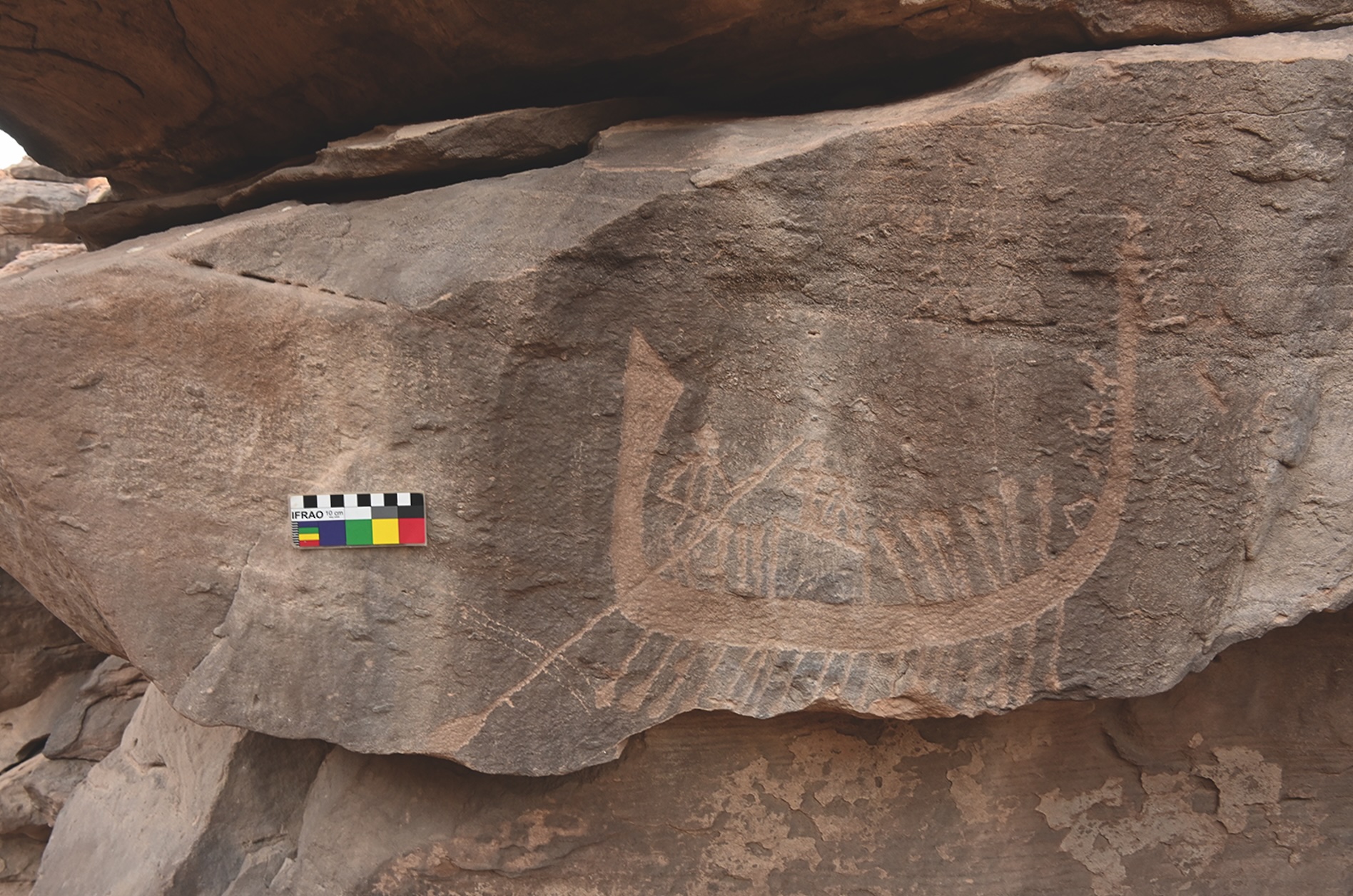 a rock carving of people rowing a boat