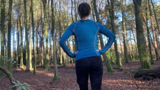 Runner in the forest wearing a blue top