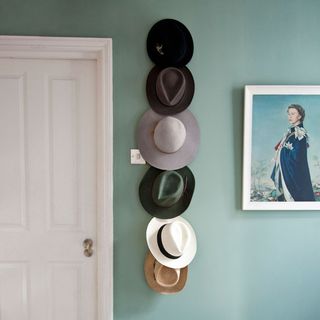 grey wall with white door and hats