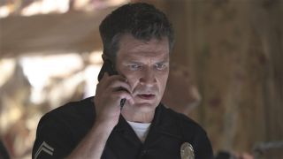 Nathan Fillion staring intensely on the phone on The Rookie.