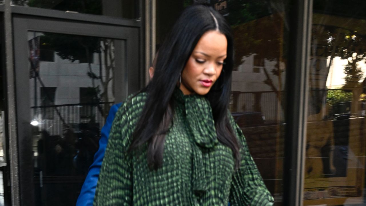 Rihanna walking in Los Angeles while carrying her Dior and Louis Vuitton bags