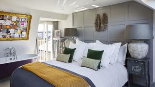 grey panelled bedroom with bath in loft conversion