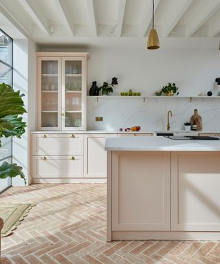 Terracotta herringbone floor by Ca Pietra with blush kitchen units