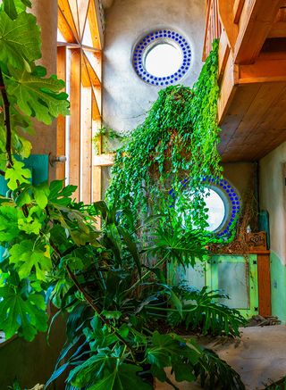 Earthship community in Taos showing colourful off grid homes nestled into the desert earth