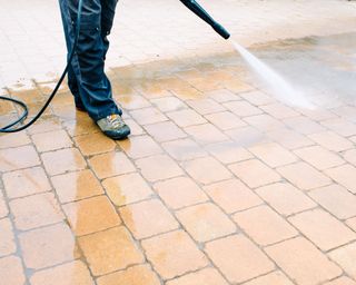 cleaning a patio with a pressure washer