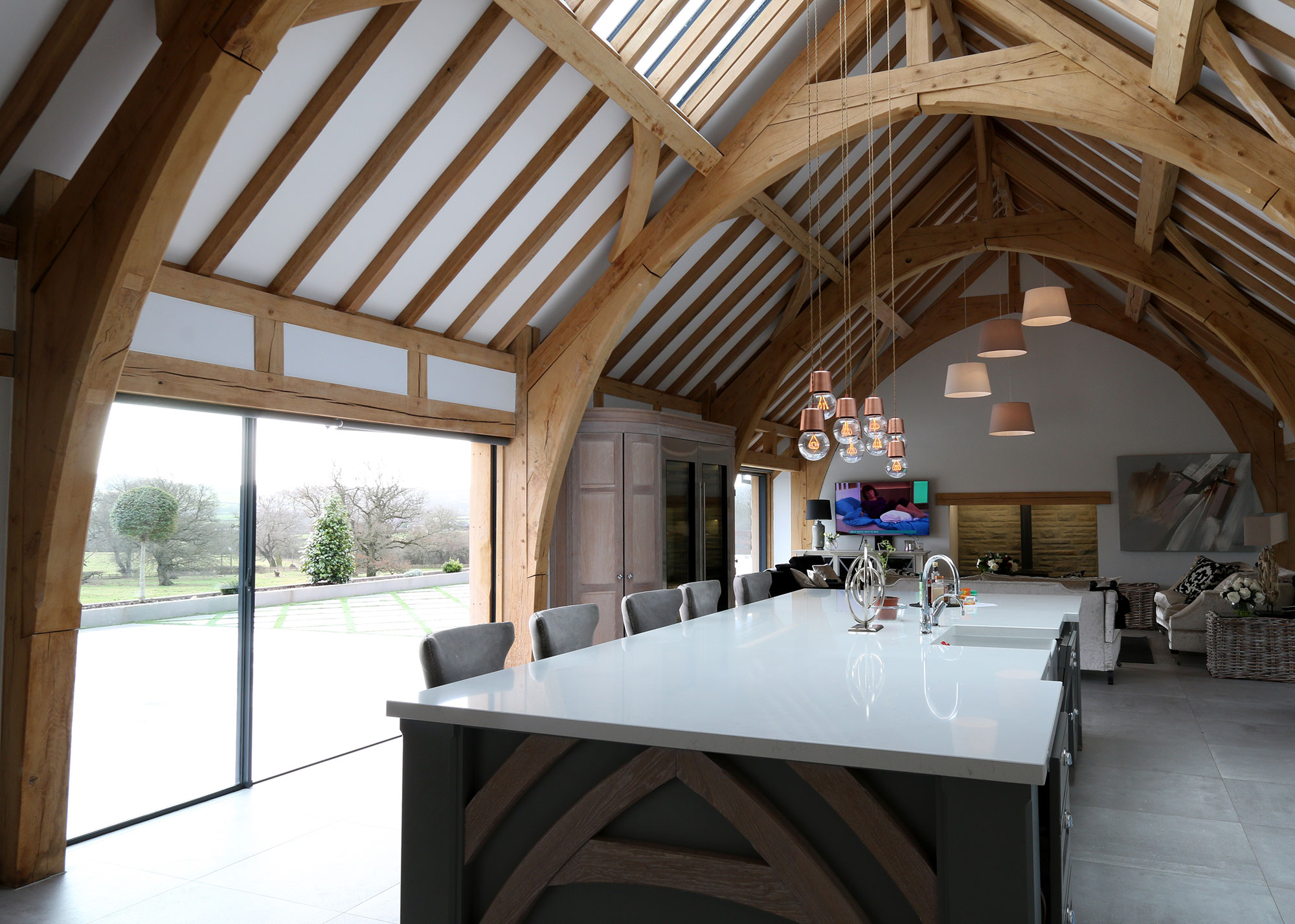 barn conversion kitchen with sliding doors and exposed timber frame