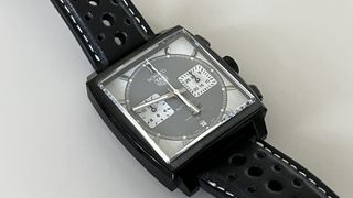 The TAG Heuer Monaco Night Drive on a grey background