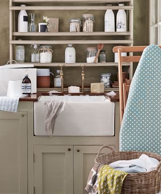 laundry room butlers sink with shelves and ironing board