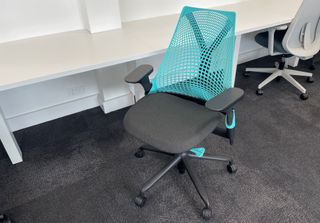 Herman Miller Sayl chair in front of a desk in office