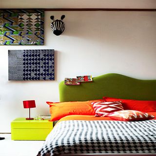 bright tribal bedroom with green headboard