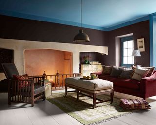 Brown painted living room with fireplace and blue ceiling