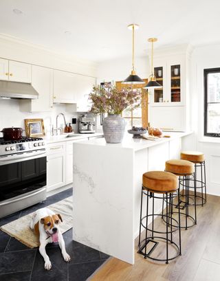 A kitchen with dark porcelain tiles on the floor