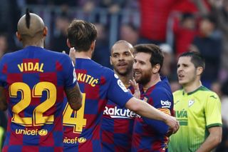 Messi is mobbed by his team-mates at the Nou Camp