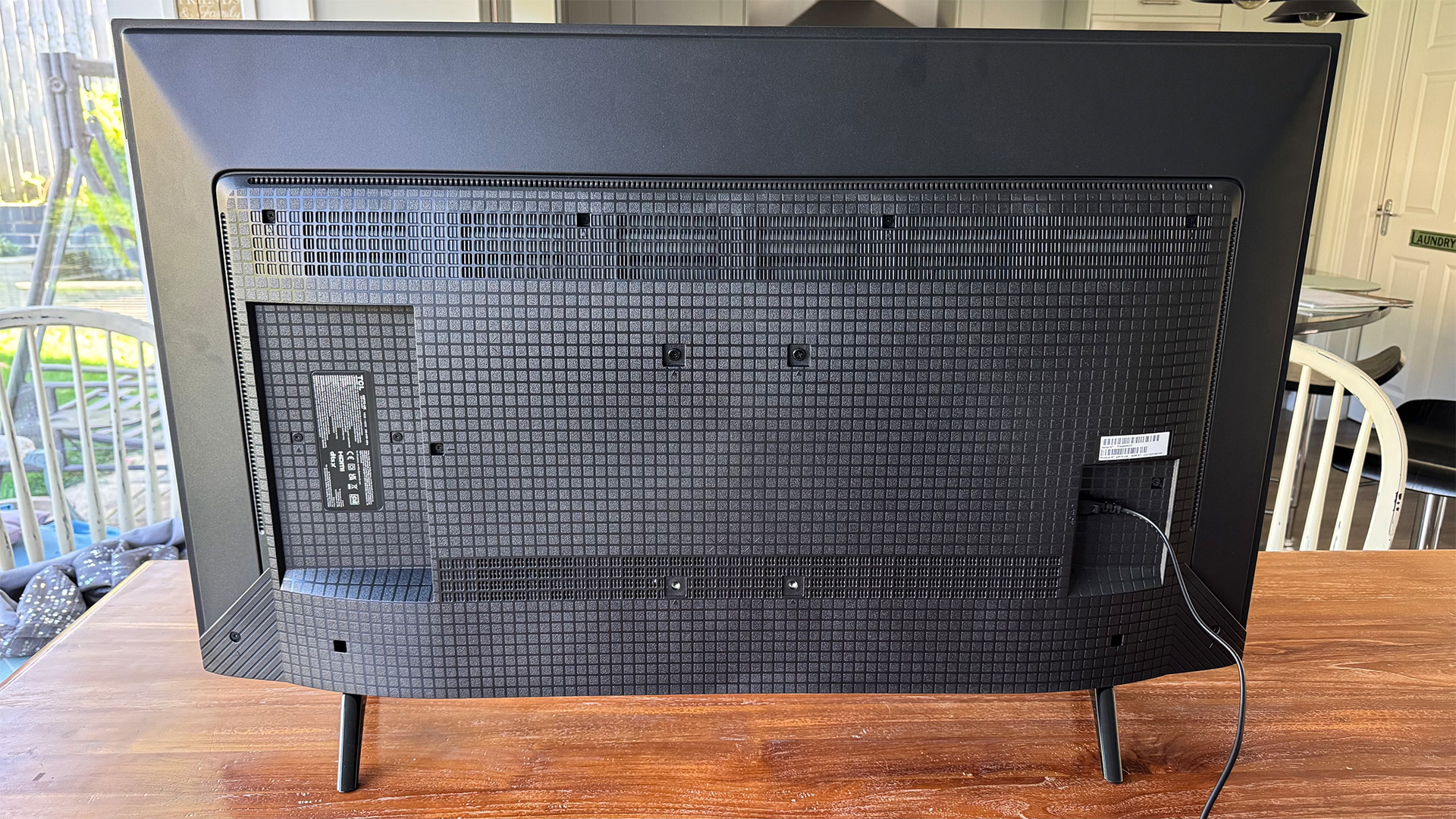 TCL P7K 43-inch TV on wooden dining table showing rear of set