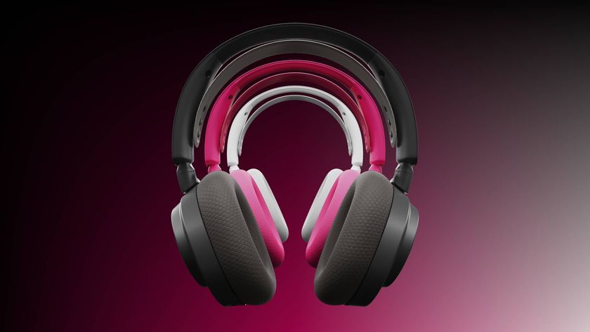 Image of a black, magenta and and white headset hovering in the middle of the frame, with a dark pink background.