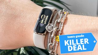 A photo of a person wearing the Fitbit Luxe on their wrist. The "Tom's Guide killer deal" tag is overlaid.