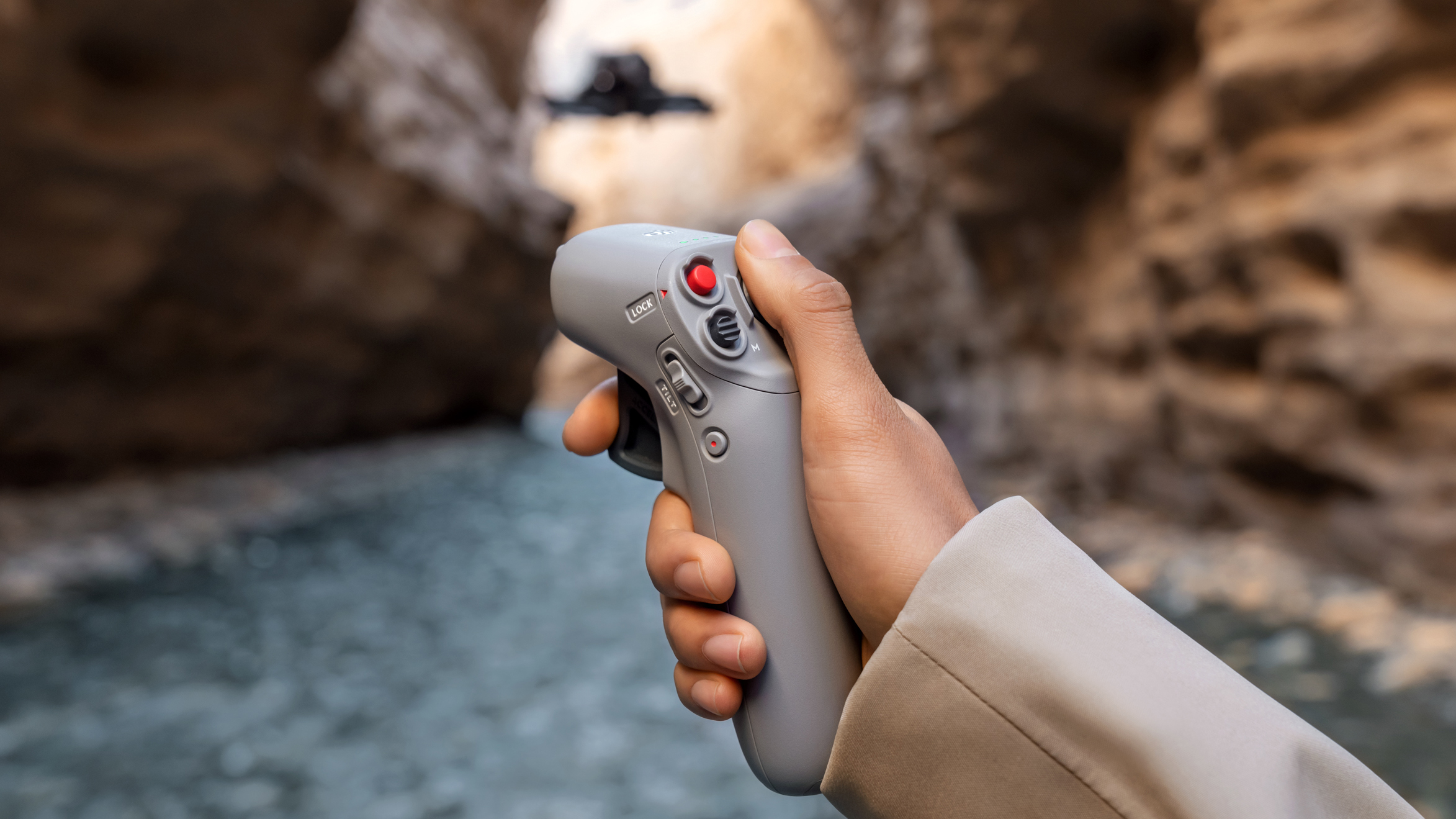 A hand holding the DJI Motion Controller