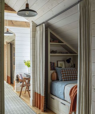 Bed nook, green and orange curtains, shelves, blue bedding
