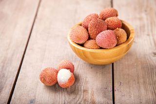 An image of lychee fruits in a bowl.