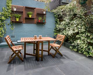 courtyard garden with table and chairs and painted wall