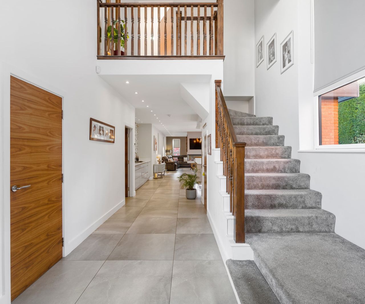 A hallway and staircase with wooden bannisters