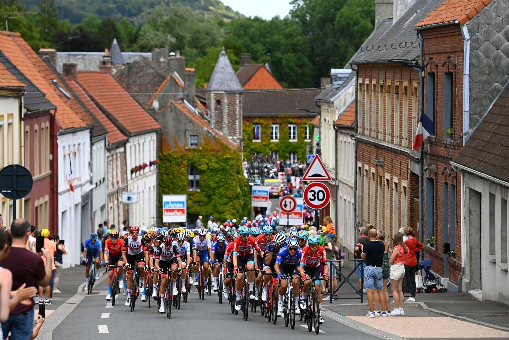 CALAIS FRANCE JULY 05 A general view of the Peloton passing through Herbinghen Village during the 109th Tour de France 2022 Stage 4 a 1715km stage from Dunkerque to Calais TDF2022 WorldTour on July 05 2022 in Calais France Photo by Tim de WaeleGetty Images