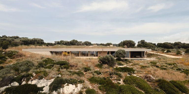 A hidden home on a greek island covered in grass