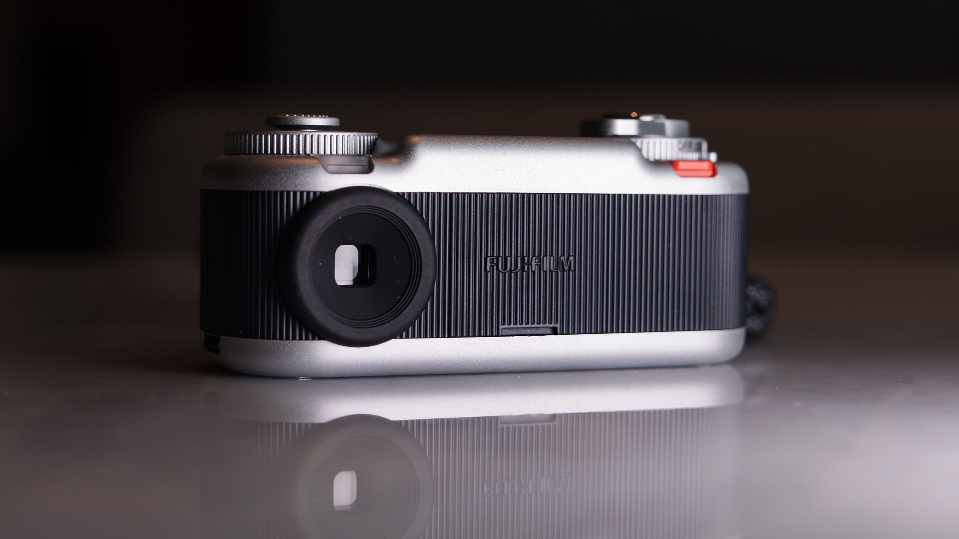 Fujifilm Instax Pal 2 digital camera on a marbled white surface, close up of the viewfinder