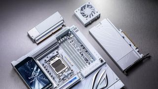 A promotional image of the Asus ROG Crosshair X870E Glacial gaming motherboard, with the included RAM cooler, Q-DIMM.2 and Hyper M.2 expansions cards set next to the board.