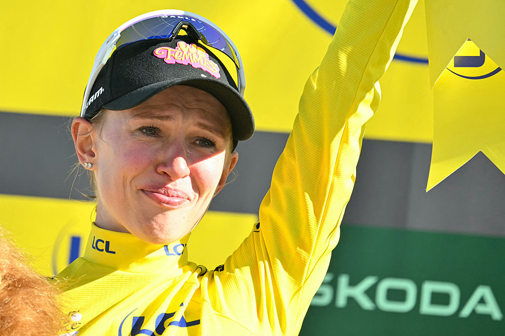 Canyon//SRAM zondacrypto's Polish rider Katarzyna Niewiadoma celebrates on the podium wearing the overall leader's yellow jersey after the 7th (out of 9) stage of the fifth edition of the Women's Tour de France cycling race, 146.8 km from Voulte-sur-Rhone to The Mont Ventoux, at The Mont Ventoux, southeastern France on August 7, 2026. (Photo by NICOLAS TUCAT / AFP)