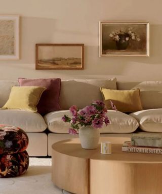 neutral anthropologie living room styled with purple and yellow accents