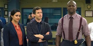 Melissa Fumero as Amy Santiago, Andy Samberg as Jake Peralta and Terry Crews as Terry Jeffords in Brooklyn Nine-Nine.