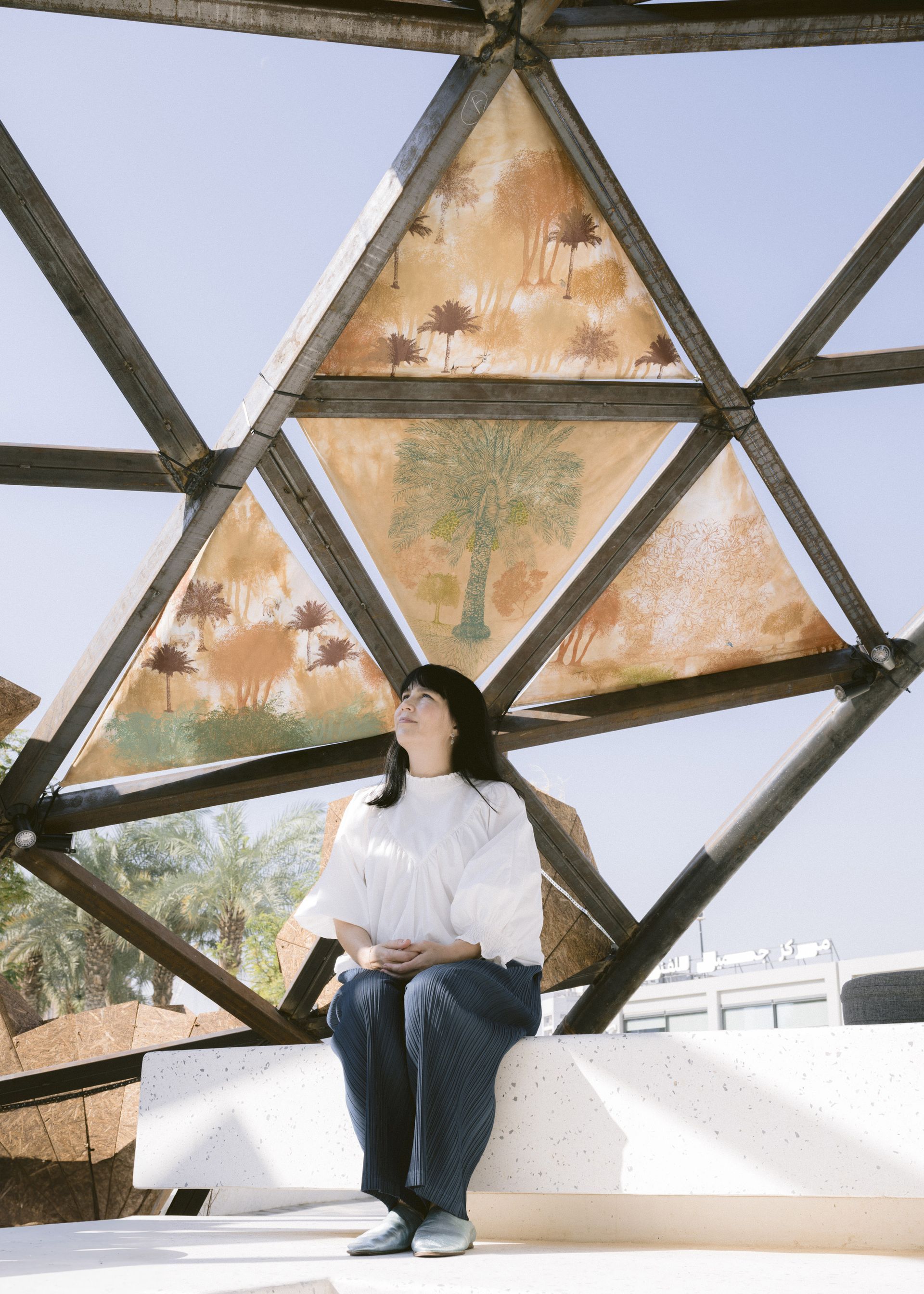 art jameel pavilion with woman sitting underneath