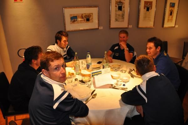 The team enjoying dinner at their Italian camp