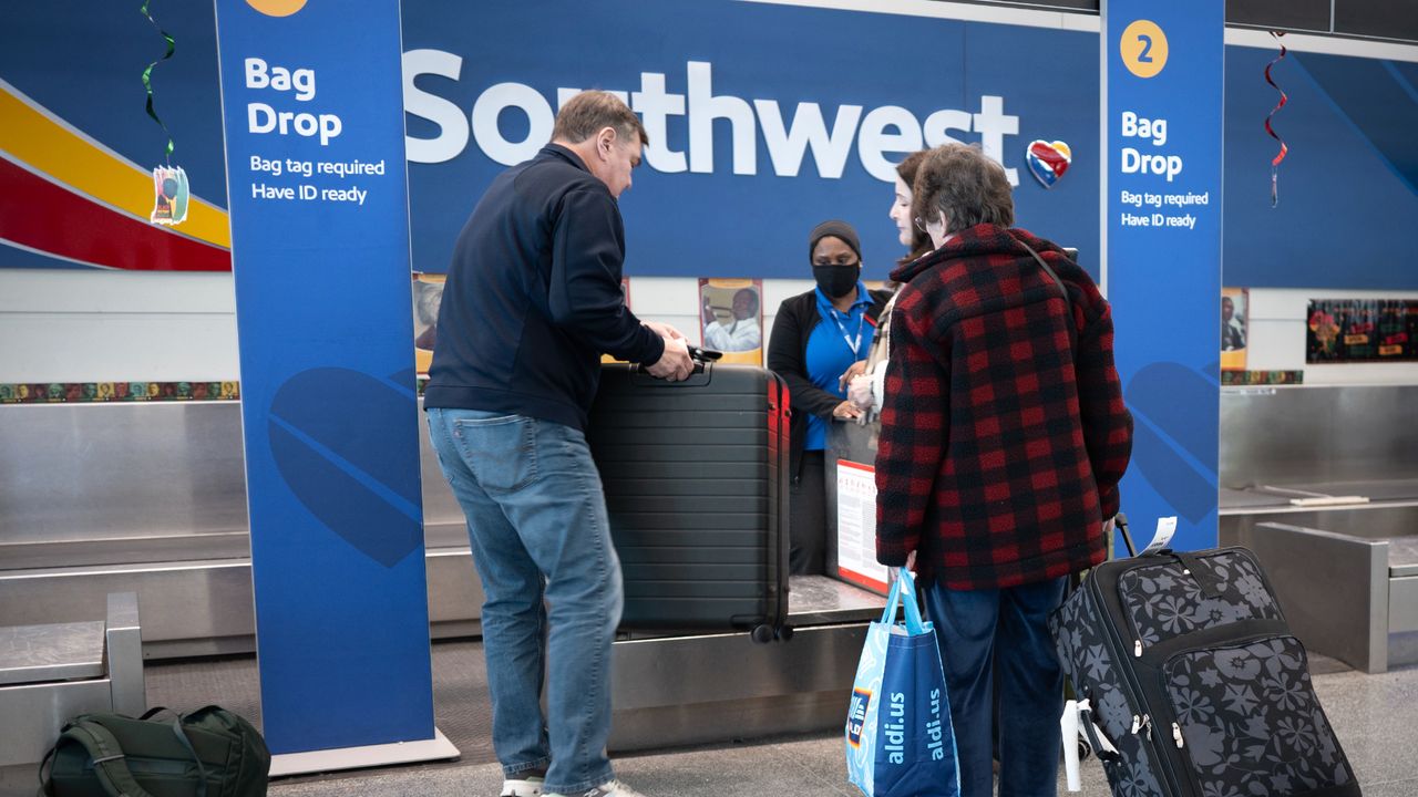 Customers drop baggage at Southwest desk in Chicago