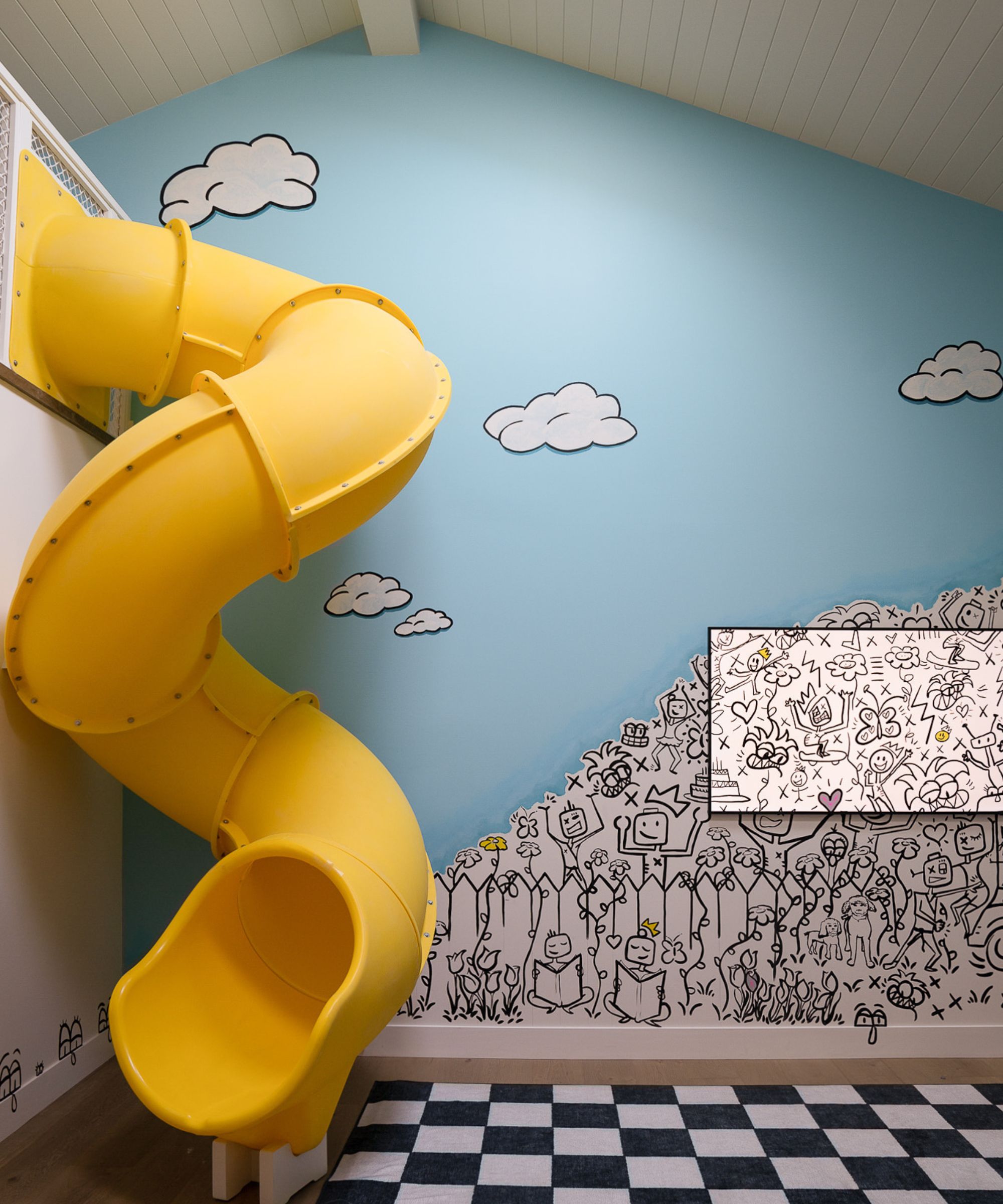 playroom with mural and yellow slide