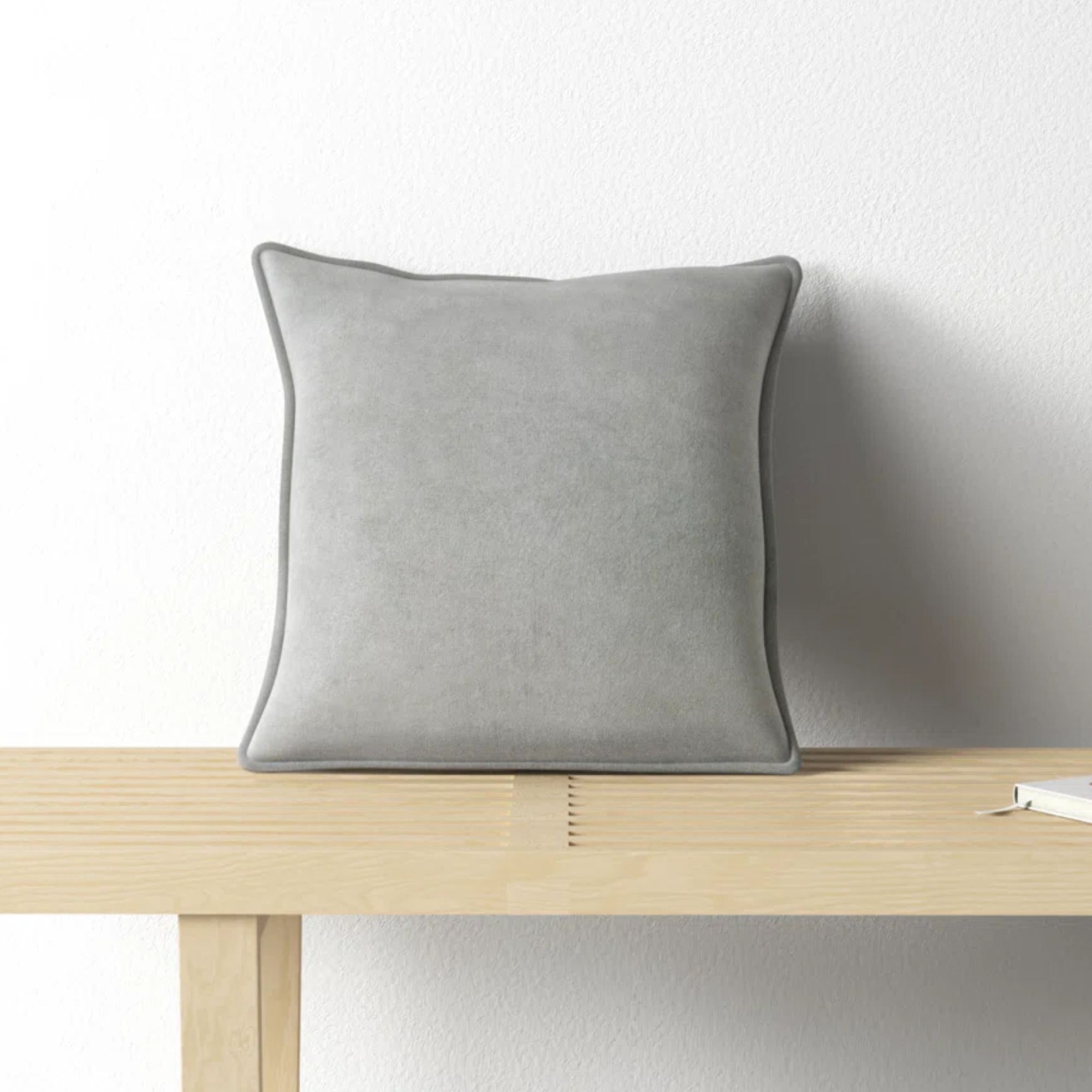 Pale gray velvet cushion with piped edges