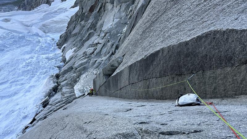 Photo from climber Paul Mcsorley showing the Arc'teryx Alpha SL backpack being hauled up a rock face on a climbing expedition